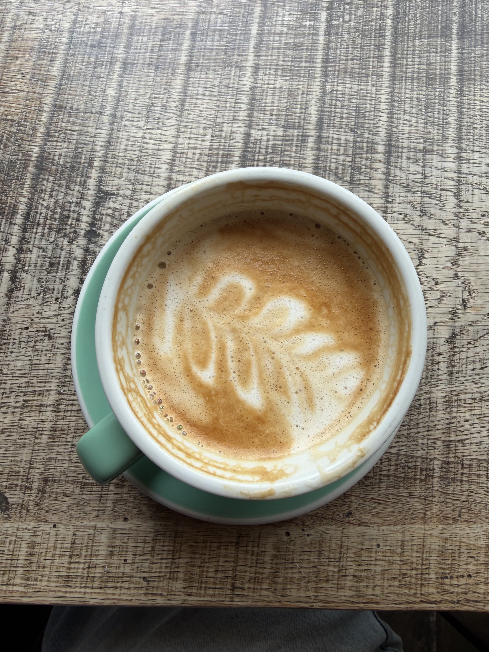 Freshly poured coffee in a green cup at Bloomfield Square
